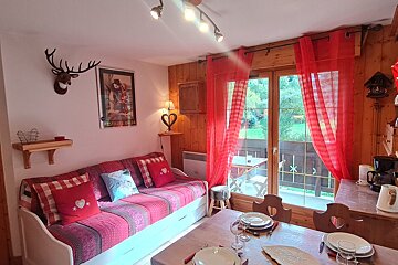 A living room with a couch and a picture on the wall that says prestige france