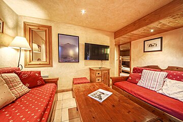 A living room with two couches and a flat screen tv