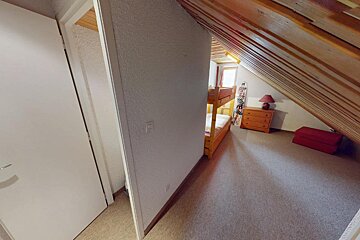 A bedroom with a bunk bed and a dresser
