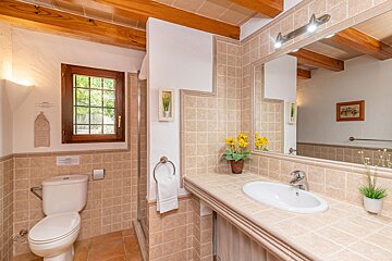 A bathroom with a toilet a sink and a mirror