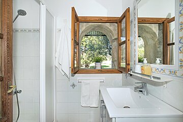 A bathroom with a sink a mirror and a window