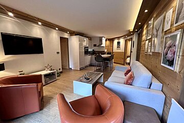 A living room with a couch and two chairs