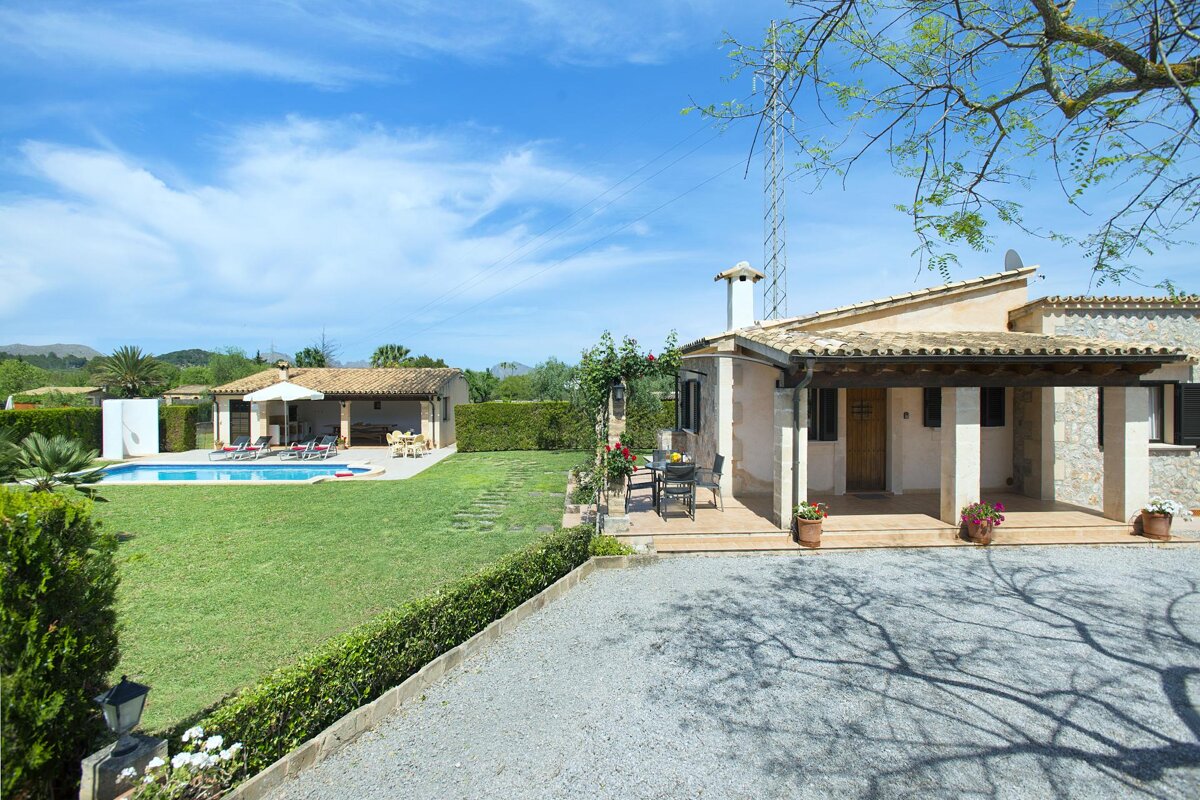 A house with a covered porch and a swimming pool