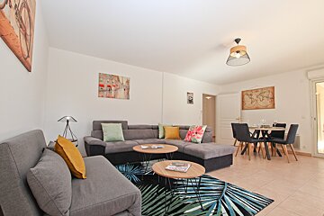 A living room with a couch and two tables