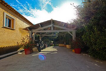 A carport with a motorcycle parked underneath it