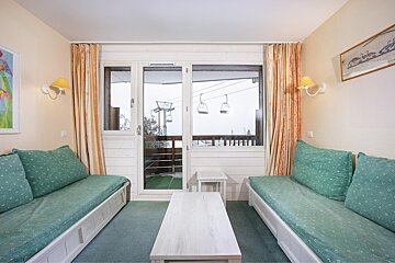 A living room with a view of a ski lift