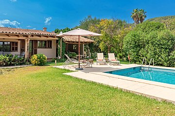 A house with a swimming pool in front of it