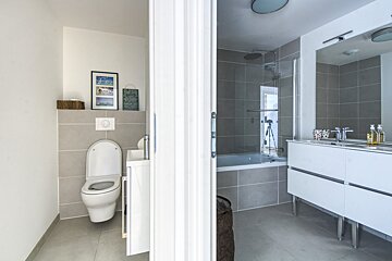 A bathroom with a sign on the wall that says