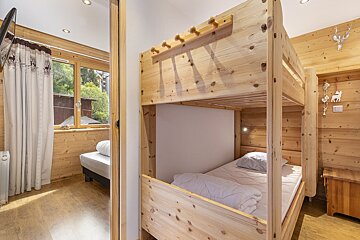 A bedroom with a bunk bed and a small bed