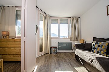 A living room with a couch and a trash can that says ' a ' on it