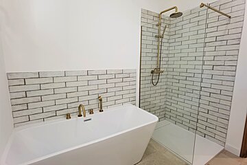 A bathroom with a bathtub and a walk in shower