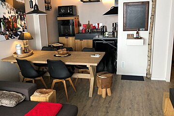 A living room with a table and chairs and a sign that says ' a ' on it