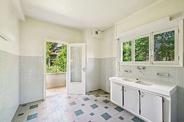 A bathroom with two sinks and a window