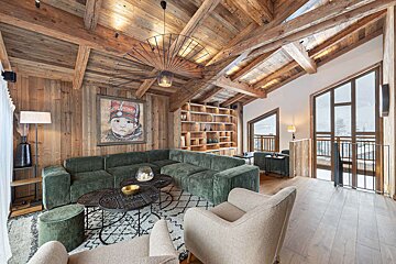 A living room with a green couch and two chairs