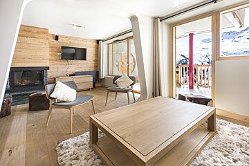 A living room with a fireplace and a flat screen tv