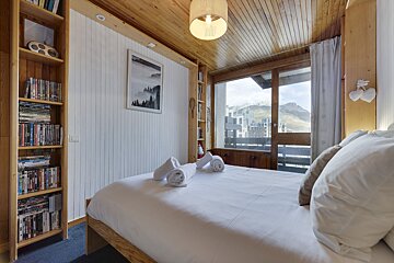 A bunk bed with a pillow that has a mountain on it