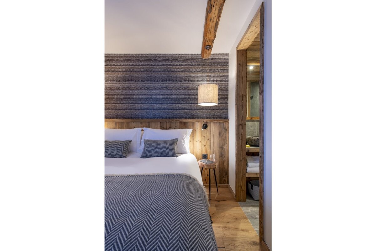 A bedroom with a king size bed and a wooden headboard