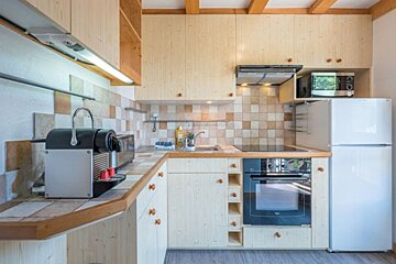 A kitchen with wooden cabinets and a bosch refrigerator