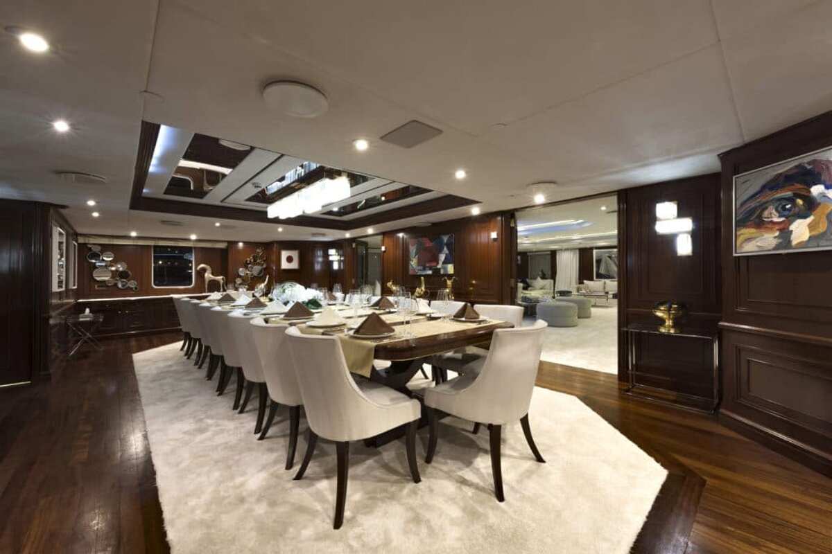 A dining room with a long table and chairs