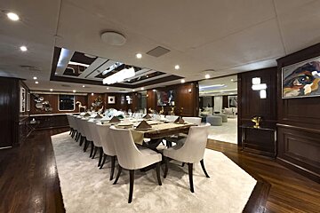 A dining room with a long table and chairs