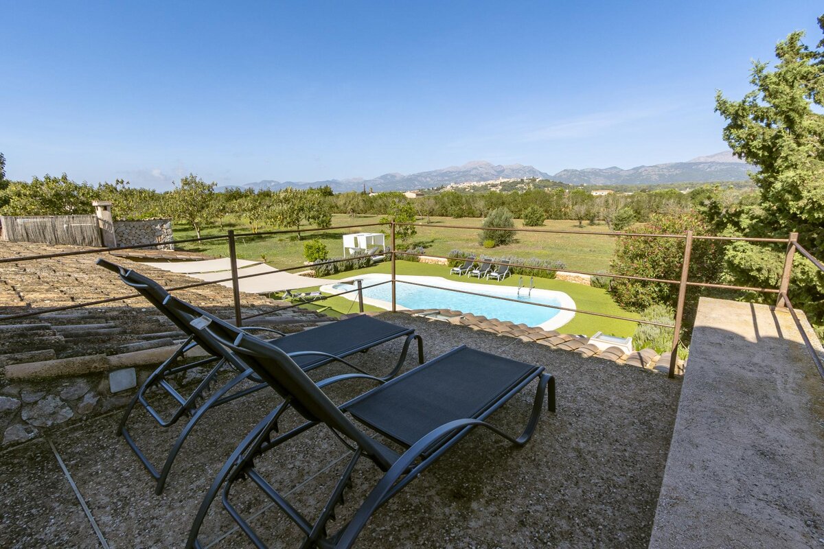 A view of a swimming pool with mountains in the background