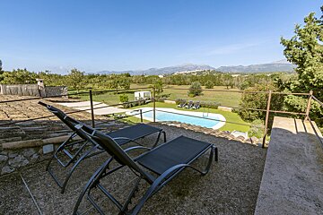 A view of a swimming pool with mountains in the background