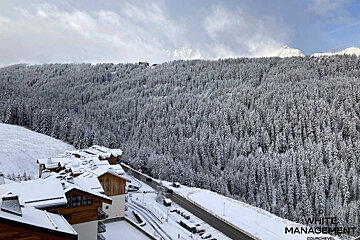 A bathroom with a sink and a mirror with a wooden frame