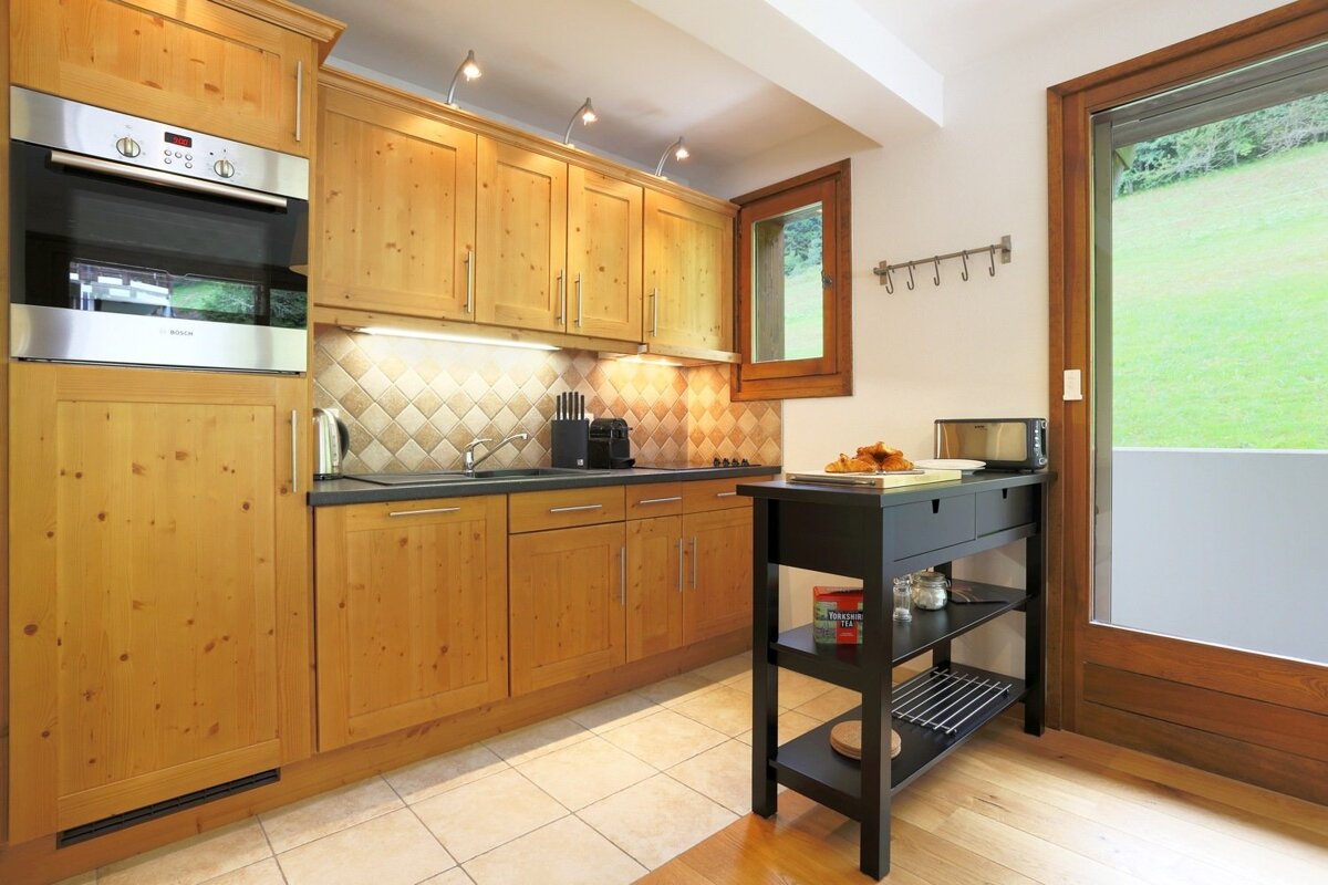 A kitchen with wooden cabinets and a bosch oven