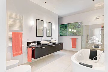 A bathroom with two sinks and a bathtub