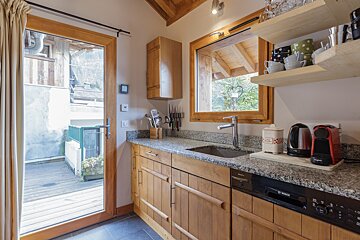 A kitchen with wooden cabinets and a bosch dishwasher
