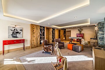 A living room with a painting of a woman in a pool on the wall