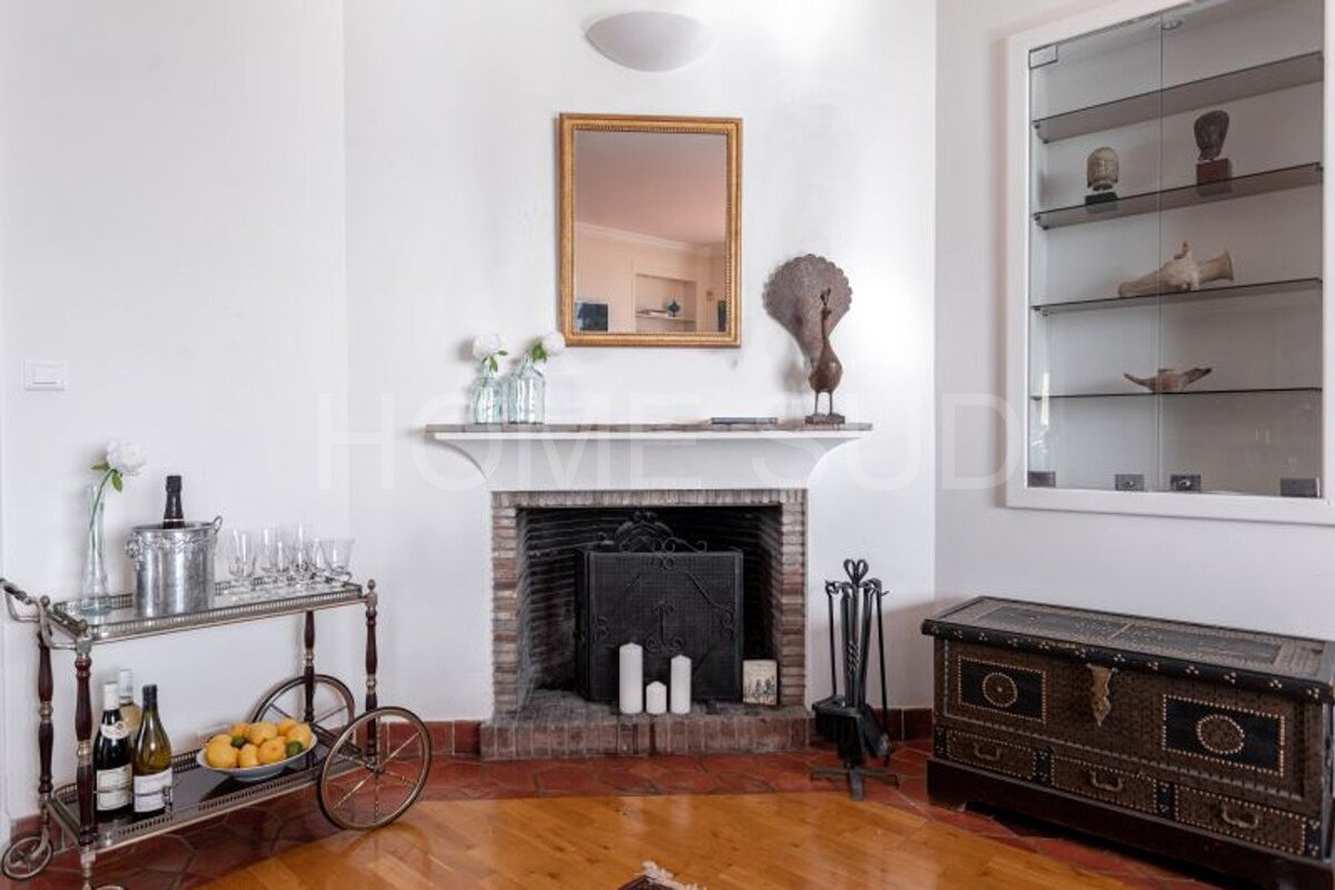 A living room with a fireplace and a bar cart