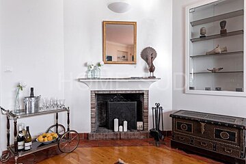 A living room with a fireplace and a bar cart