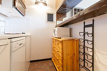 A kitchen with a microwave that says potato on it