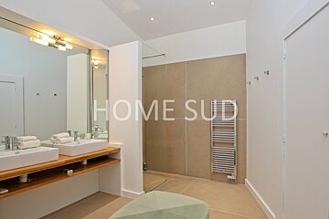 A bathroom with two sinks and a towel rack that says home sud