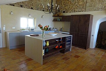 A kitchen with a vase of flowers on the counter