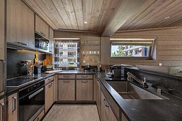 A kitchen with stainless steel appliances and wooden cabinets