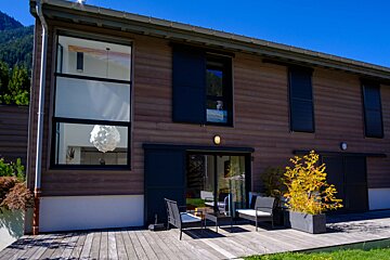 A house with a lot of windows and sliding glass doors