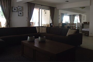 A living room with a large sectional couch and a coffee table