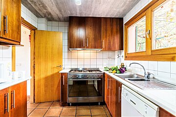 A kitchen with stainless steel appliances and wooden cabinets
