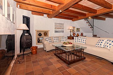 A living room with a white couch and a glass coffee table