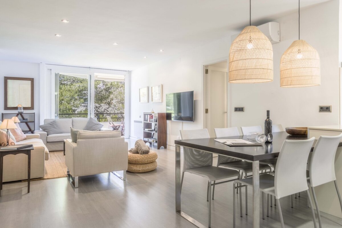 A living room with a dining table and chairs