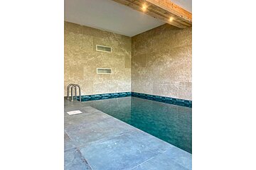 A swimming pool with a ladder leading to it