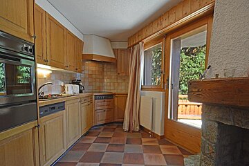 A kitchen with stainless steel appliances and wooden cabinets