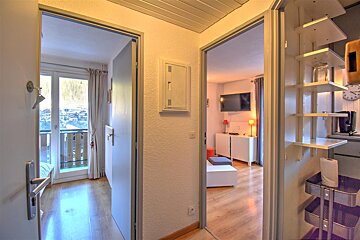 A hallway in a house with a clock on the wall