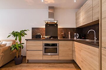 A kitchen with stainless steel appliances and wooden cabinets