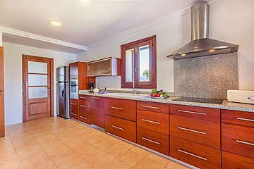 A kitchen with stainless steel appliances and wooden cabinets