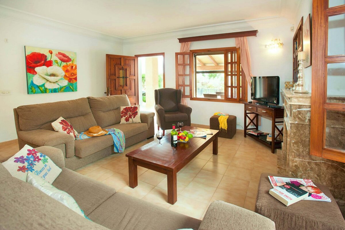 A living room with a painting on the wall that says