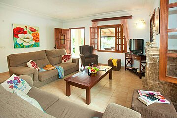 A living room with a painting on the wall that says