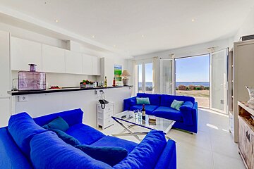 A living room with a blue couch and a blue table